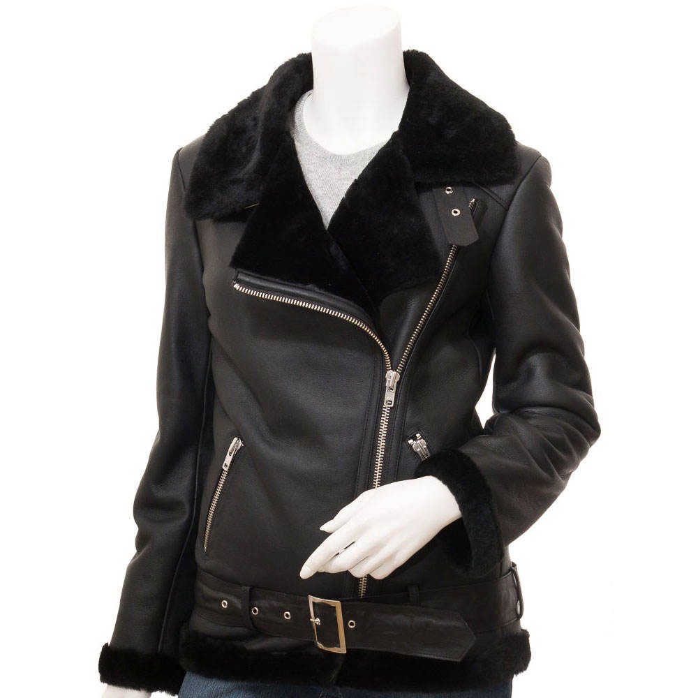 Women's black leather shearling biker jacket with fur collar, asymmetric zipper, zippered pockets, cuffs, and waist belt