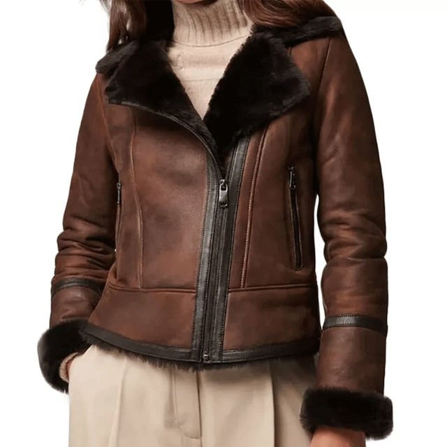 Women's brown leather shearling jacket with black fur collar, fur cuffs, front zipper, and zippered pockets